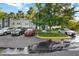 Reserved parking spaces in front of the property with a well-maintained landscaped area and mature trees at 2202 Clubside Dr # 2202, Longwood, FL 32779