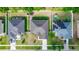 An aerial view showcasing the roof and backyard with green lawns and a glimpse of a trampoline at 2258 Ardon Ave, Orlando, FL 32833