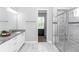 Bathroom featuring double vanity, granite countertops, tiled shower with glass door, and great natural light at 2258 Ardon Ave, Orlando, FL 32833