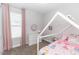 Bright bedroom with a princess themed bed, plush carpet, and a window with pink drapes at 2258 Ardon Ave, Orlando, FL 32833