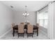 Traditional dining room with a chandelier, wood table, six chairs, and a window with sheer white curtains at 2258 Ardon Ave, Orlando, FL 32833