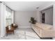 A living room with white walls, a couch, two armchairs, wood-look tile flooring, and natural light at 2258 Ardon Ave, Orlando, FL 32833