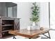 Living room featuring wood furniture, a modern tv, and books and foliage on a coffee table at 2258 Ardon Ave, Orlando, FL 32833