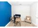 Bright office space featuring a blue accent wall, a beige chair and carpet, and wood desk at 2258 Ardon Ave, Orlando, FL 32833