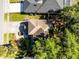 Overhead view of a home with a yard and driveway, surrounded by mature trees and greenery at 2606 Teeside Ct, Kissimmee, FL 34746