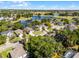 Aerial view of a residential neighborhood featuring lush landscaping, ponds, and community golf course at 2606 Teeside Ct, Kissimmee, FL 34746