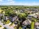 Aerial shot of a home with a spacious yard in a community, featuring mature trees and landscaping at 2606 Teeside Ct, Kissimmee, FL 34746