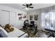 Bedroom featuring white walls, wood floor, bed, desk, shelves, and a window with sheer curtains at 2606 Teeside Ct, Kissimmee, FL 34746