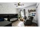 This Bedroom features a crib, gray walls, wood floors, and a glider with black trim at 2606 Teeside Ct, Kissimmee, FL 34746