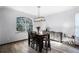 Elegant dining room with modern light fixture, stylish sideboard and large window at 2606 Teeside Ct, Kissimmee, FL 34746