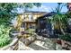 Home's exterior with a pond, a gazebo, and a paved backyard, surrounded by lush greenery at 2606 Teeside Ct, Kissimmee, FL 34746