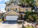 Charming two-story home with a manicured lawn, a two car garage, and a stone facade at 2606 Teeside Ct, Kissimmee, FL 34746