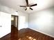 Spacious bedroom features a ceiling fan and rich hardwood flooring at 2612 Robert Trent Jones Dr # 710, Orlando, FL 32835