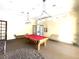 Well-lit game room with a red pool table and cozy seating arrangements at 2612 Robert Trent Jones Dr # 710, Orlando, FL 32835