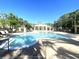 Resort-style swimming pool with lounge chairs and lush landscaping surrounding the area at 2612 Robert Trent Jones Dr # 710, Orlando, FL 32835