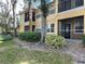 Multi-story condo with yellow siding, private balconies, and well-maintained landscaping, creating a welcoming curb appeal at 2624 Robert Trent Jones Dr # 610, Orlando, FL 32835