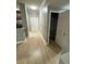 Hallway with a closet for extra storage, leading to the front door and connecting to the kitchen at 2624 Robert Trent Jones Dr # 610, Orlando, FL 32835