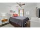 Cozy bedroom with a grey bedspread, wood floors, and natural light from the window at 2787 Lido Key Dr, Kissimmee, FL 34747