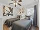 Bedroom with twin beds, stylish decor, and hardwood floors at 2787 Lido Key Dr, Kissimmee, FL 34747