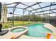 Inviting pool and spa in a screened-in enclosure, offering a relaxing backyard retreat at 2787 Lido Key Dr, Kissimmee, FL 34747