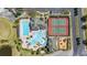 Aerial view of community with large pool, clubhouse, two tennis courts, playground, and parking at 430 Brunswick Dr, Davenport, FL 33837