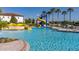 Community pool with blue water slides and surrounding lounge chairs and umbrellas at 430 Brunswick Dr, Davenport, FL 33837