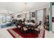 Elegant dining room with a large wooden table, chandelier, and a view into the living area at 430 Brunswick Dr, Davenport, FL 33837