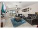 Comfortable living room with leather sofas, area rug, ceiling fan, and sliding glass doors to the lanai at 430 Brunswick Dr, Davenport, FL 33837