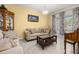 Cozy living room featuring neutral tones, comfortable seating, and natural light at 430 Brunswick Dr, Davenport, FL 33837