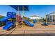 Community playground featuring blue slides, climbing structures and shade cover at 430 Brunswick Dr, Davenport, FL 33837