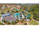 Aerial view shows community pool, clubhouse and play area surrounded by lush landscaping at 4416 Shiva Loop, Kissimmee, FL 34746