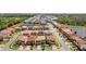 Overhead shot of a neighborhood with a lake, multiple homes, and tree lined streets at 4416 Shiva Loop, Kissimmee, FL 34746