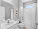 Well-lit bathroom showcasing a vanity, toilet, framed artwork and a shower-tub combo at 4416 Shiva Loop, Kissimmee, FL 34746