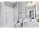 Bright bathroom featuring a shower-tub combo, white vanity, and modern fixtures at 4416 Shiva Loop, Kissimmee, FL 34746