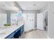 Bright bathroom featuring double vanity, a walk-in shower with glass door and tile flooring at 4416 Shiva Loop, Kissimmee, FL 34746