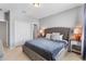 Well-lit bedroom featuring neutral paint, a plush upholstered bed, and double doors at 4416 Shiva Loop, Kissimmee, FL 34746