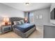 Well-lit bedroom featuring neutral paint, a plush upholstered bed, and large window at 4416 Shiva Loop, Kissimmee, FL 34746