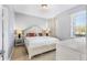 Bright bedroom featuring neutral walls, carpet, and a queen bed with white wooden headboard at 4416 Shiva Loop, Kissimmee, FL 34746