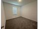 Cozy bedroom featuring plush carpet and a window offering natural light at 5111 Lake Hamlin Trl, Winter Garden, FL 34787