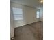 Neutral bedroom with carpet flooring and natural light from two windows at 5111 Lake Hamlin Trl, Winter Garden, FL 34787