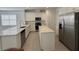 Bright kitchen featuring stainless steel appliances, a large island, and sleek white cabinets at 5111 Lake Hamlin Trl, Winter Garden, FL 34787