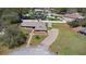 Aerial view of a landscaped property with a shed, long driveway, and well-maintained lawn at 516 Donaldson Dr, Debary, FL 32713