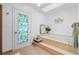 Bright bathroom featuring a soaking tub with tile surround and a decorative glass-paneled door to the exterior at 516 Donaldson Dr, Debary, FL 32713