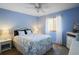 Charming bedroom features a nautical theme with blue walls, a queen bed, and complemented by white furnishings at 516 Donaldson Dr, Debary, FL 32713