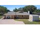 Lovely single-story brick home featuring a spacious driveway and backyard shed at 516 Donaldson Dr, Debary, FL 32713