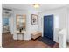 Inviting foyer with wood flooring, mirror, bench, and a blue front door at 516 Donaldson Dr, Debary, FL 32713