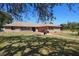 Charming brick home featuring a well-manicured lawn with mature shade trees at 516 Donaldson Dr, Debary, FL 32713