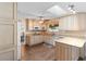 Bright kitchen featuring light wood cabinets, granite countertops, and a skylight for ample natural light at 516 Donaldson Dr, Debary, FL 32713