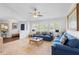 Bright living room featuring large windows and stylish blue sofas at 516 Donaldson Dr, Debary, FL 32713