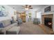 Comfortable living room featuring a fireplace, plush seating, and views into the kitchen area at 516 Donaldson Dr, Debary, FL 32713